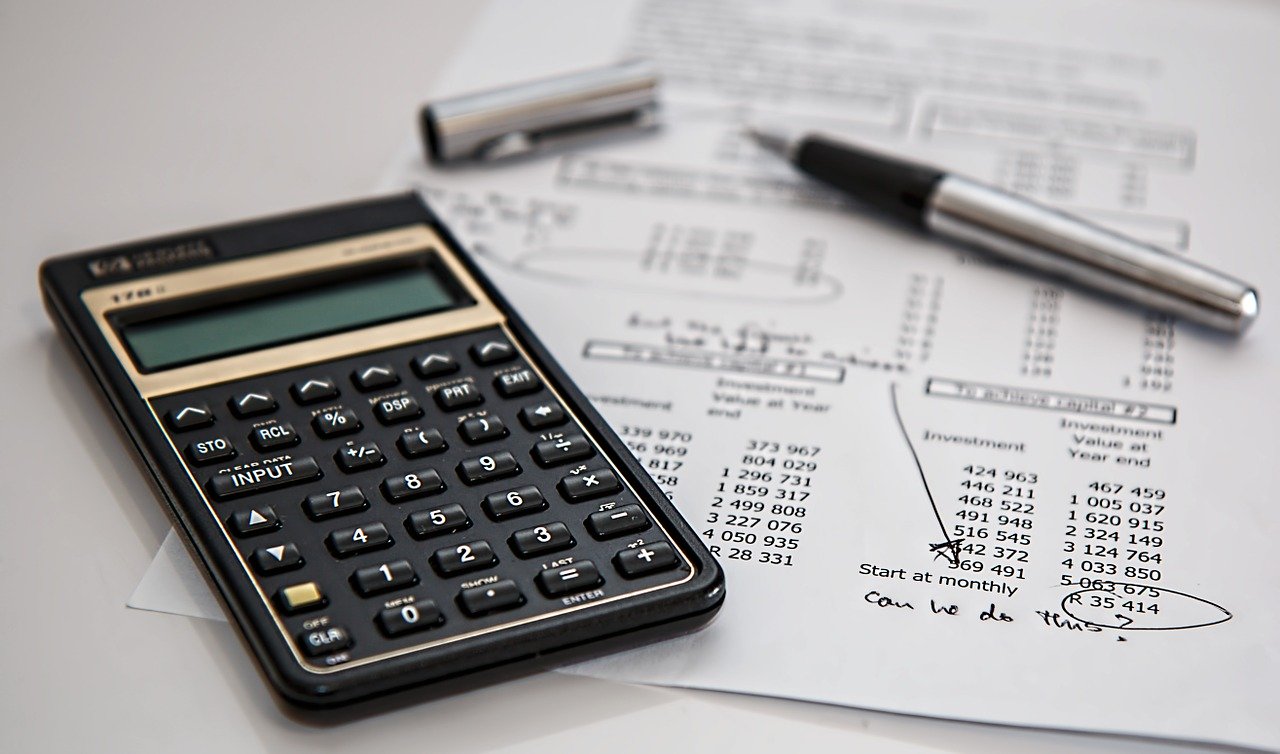 A bookkeeper's calculator sitting on top of a ledger she is working on for a law firm client